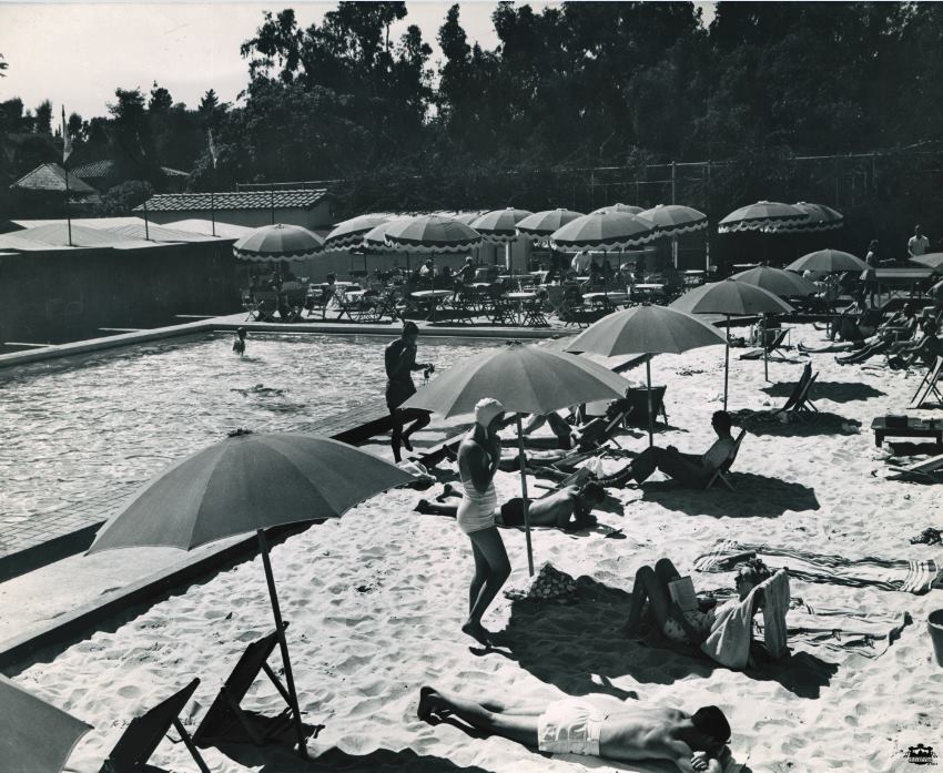 Before the signature green-and-white striped loungers at the Beverly Hills Hotel pool - there was sand! It was officially known as The Beverly Hill's Sand and Pool Club (photo circa 1938). Before the signature green-and-white striped loungers at the Beverly Hills Hotel pool - there was sand! It was officially known as The Beverly Hill's Sand and Pool Club (photo circa 1938).