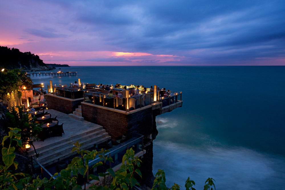 Located on natural rocks 14 meters above the Indian Ocean at the base of AYANA Resort and Spa Bali's towering cliffs, this innovative open-top Bali bar is the island’smost glam sunset and after-dark destination Located on natural rocks 14 meters above the Indian Ocean at the base of AYANA Resort and Spa Bali's towering cliffs, this innovative open-top Bali bar is the island’smost glam sunset and after-dark destination