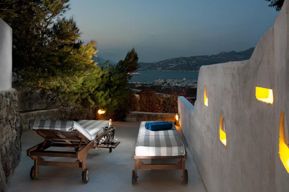 Enjoy a Glass of Wine Looking Over the Private Balcony at Tharroe Mykonos Enjoy a Glass of Wine Looking Over the Private Balcony at Tharroe Mykonos