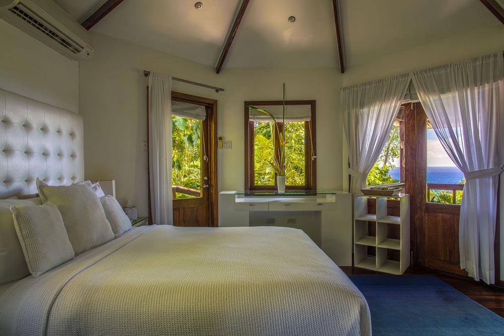 Highlighted by its lush rain forest surrounds, Mento is the ultimate nest for luxurious escape at the Geejam Hotel in Jamaica. This deluxe cabin also features an indoor bathroom with a steam room leading onto a patio, complete with a Jacuzzi and hammock for morning and evening relaxation. Located in a private niche, Mento fuses all the intimacy of a secluded hideaway. The cabin's high ceilings and white linens lend an atmosphere of elegant minimalism, complimented by a sweeping panoramic overlook of forest and sea from the extended veranda. Highlighted by its lush rain forest surrounds, Mento is the ultimate nest for luxurious escape at the Geejam Hotel in Jamaica. This deluxe cabin also features an indoor bathroom with a steam room leading onto a patio, complete with a Jacuzzi and hammock for morning and evening relaxation. Located in a private niche, Mento fuses all the intimacy of a secluded hideaway. The cabin's high ceilings and white linens lend an atmosphere of elegant minimalism, complimented by a sweeping panoramic overlook of forest and sea from the extended veranda.