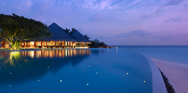 Pool by the Sea during Evening at Dusit Thani Maldives