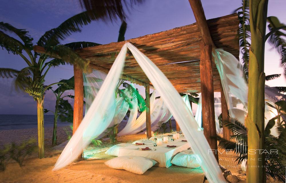 White drapery low table and pillow seating on the beach at Secrets Capri Riviera Cancun in Playa del Carmen, Mexico