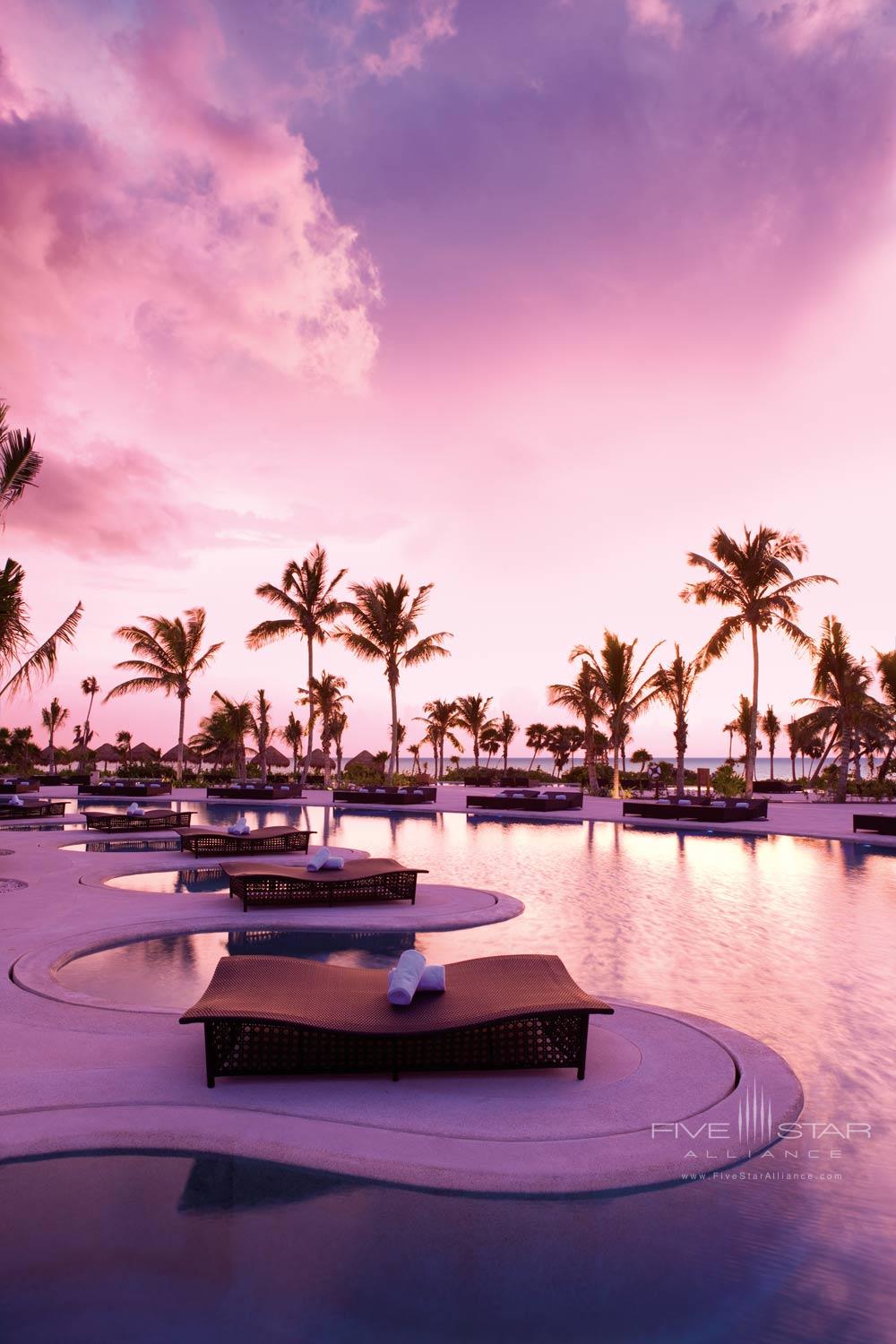 Lounge chairs at the infinity pool at Secrets Maroma Beach Riviera Cancun in Playa Del Carmen, QR, Mexicol