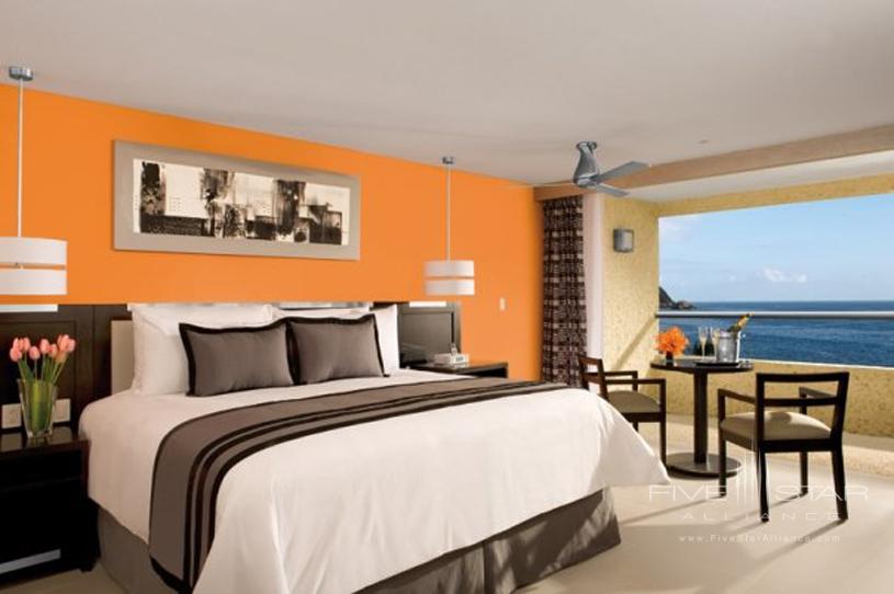 King Bed in Guest Room with Ocean View at Dreams Huatulco Resort and Spa