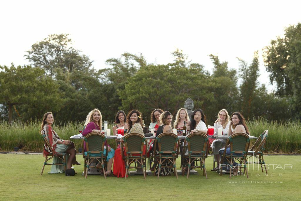 Lumeria Maui dining outside on the garden terrace by Buddha