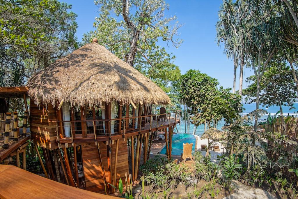 At Nihi Sumba Island, formerly Nihiwatu Resort, the Mamole Treehouses are built around the trunk of a tree. The 3 separate but conjoining villas offer balconies overlooking the ocean.